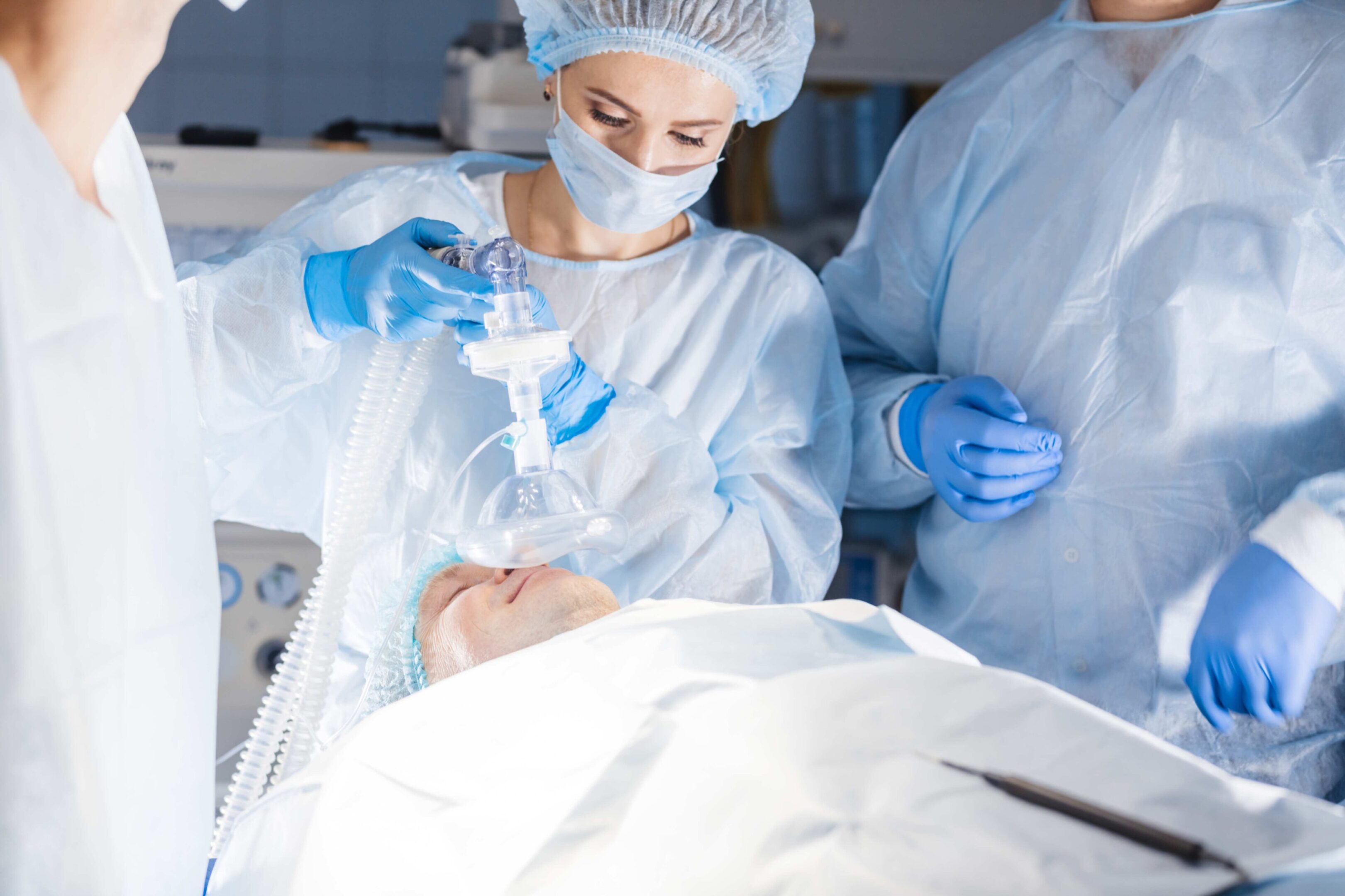 Medical team performing surgery in operating room.