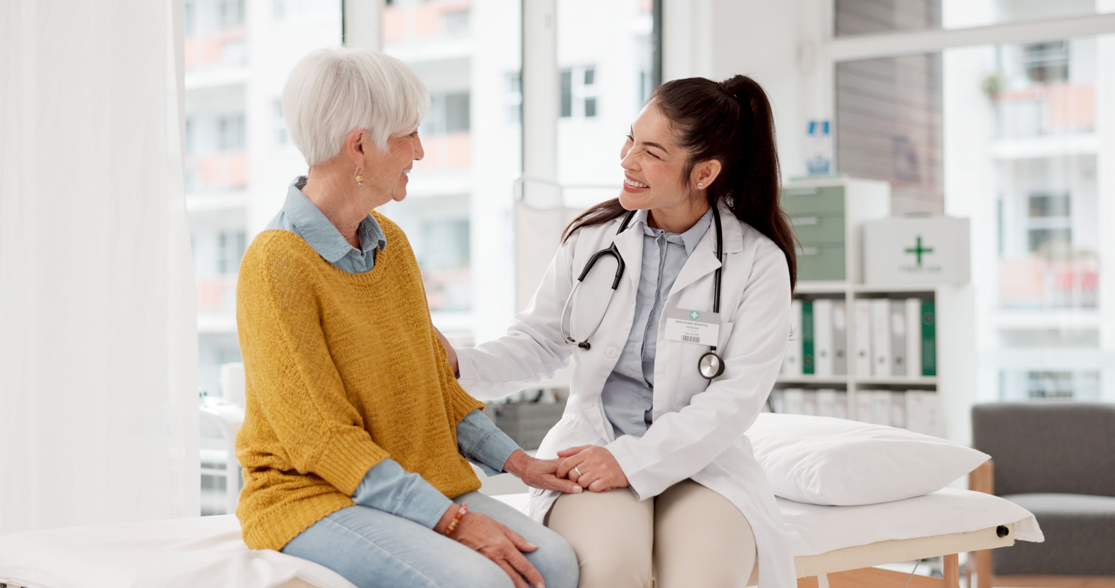 Doctor comforting patient in medical office.