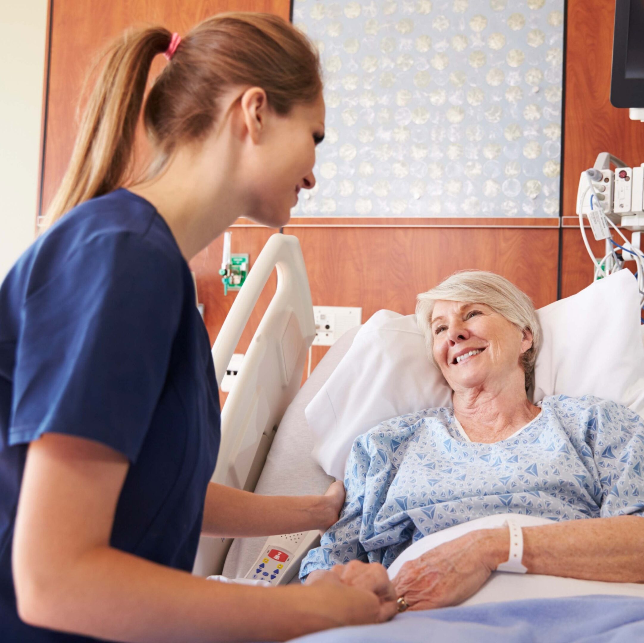 Nurse caring for elderly patient in hospital.